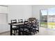 Dining room features table with seating for six with a sliding glass door providing lake views at 16051 Weathered Windmill Ter, Odessa, FL 33556
