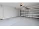 A clean, empty two-car garage with a door leading inside the house at 16051 Weathered Windmill Ter, Odessa, FL 33556