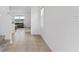 Hallway with tile floors connecting to the living room with views of the lake at 16051 Weathered Windmill Ter, Odessa, FL 33556