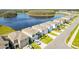 Rows of houses in a neighborhood near a lake offer scenic views and a Gathering-friendly atmosphere at 16051 Weathered Windmill Ter, Odessa, FL 33556