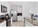 Modern kitchen featuring stainless steel appliances, granite counters, and tile flooring at 16051 Weathered Windmill Ter, Odessa, FL 33556