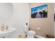 A stylish powder room featuring a round mirror and beachy wall art at 16051 Weathered Windmill Ter, Odessa, FL 33556