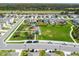 Aerial view of the community playground and green space surrounded by homes and landscaping at 16170 Traditional Bluff Pl, Odessa, FL 33556