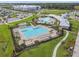 Expansive aerial view of the community pool, playground, and manicured green spaces showcasing the community amenities at 16170 Traditional Bluff Pl, Odessa, FL 33556