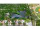 Overhead view of a property next to a pond with other homes in a residential area at 1754 Patricia Ave, Dunedin, FL 34698