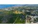 Expansive aerial view showcasing a neighborhood near lush greenery and park with city views beyond at 1754 Patricia Ave, Dunedin, FL 34698