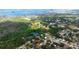 Aerial view of property, showcasing proximity to ball fields, lush greenery, and bay at 1754 Patricia Ave, Dunedin, FL 34698