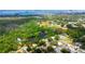 Aerial view showcases the property's location near a pond, ball fields, and bay waters at 1754 Patricia Ave, Dunedin, FL 34698