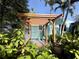 Backyard with a wooden pergola and lush landscaping with lots of greenery at 1754 Patricia Ave, Dunedin, FL 34698