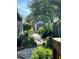 Backyard with a path, shed, and lush landscaping with lots of greenery at 1754 Patricia Ave, Dunedin, FL 34698