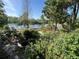 Beautiful backyard landscaping and tranquil water views enhance this lovely homes outdoor space at 1754 Patricia Ave, Dunedin, FL 34698