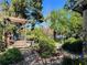 Scenic backyard featuring a wooden deck, mature trees, and a tranquil lake view at 1754 Patricia Ave, Dunedin, FL 34698