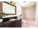 Cozy bathroom featuring a wooden vanity and a tub and shower combination at 1754 Patricia Ave, Dunedin, FL 34698