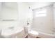 Bright bathroom featuring a decorative sink and a tub and shower combination at 1754 Patricia Ave, Dunedin, FL 34698