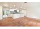 Bright kitchen featuring an island, white cabinetry, stainless steel appliances and terracotta floors at 1754 Patricia Ave, Dunedin, FL 34698
