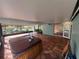 Large covered patio featuring a hot tub, tile flooring, and views of the water at 1754 Patricia Ave, Dunedin, FL 34698