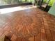 Close up of screen patio brick flooring with a large brick medallion at 1754 Patricia Ave, Dunedin, FL 34698