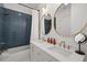 Modern bathroom with double sinks, gold fixtures, and blue tiled walls at 19 Somerset St, Clearwater Beach, FL 33767