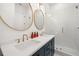 Elegant bathroom featuring a double vanity, modern fixtures, and a glass-enclosed shower, ideal for everyday luxury at 19 Somerset St, Clearwater Beach, FL 33767