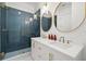 Modern bathroom featuring double sinks, quartz counters, gold fixtures and a sleek, glass shower at 19 Somerset St, Clearwater Beach, FL 33767