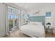 Bright bedroom featuring large windows, a comfortable bed, and serene decor, creating a peaceful retreat at 19 Somerset St, Clearwater Beach, FL 33767