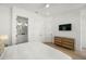 Calm bedroom boasts a natural wood dresser, with en-suite bathroom access at 19 Somerset St, Clearwater Beach, FL 33767