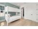 Comfortable bedroom features light wood flooring, bunk beds and private en-suite bathroom at 19 Somerset St, Clearwater Beach, FL 33767