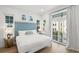 Charming bedroom with a queen-sized bed, bright decor, and a large window, filling the space with natural light at 19 Somerset St, Clearwater Beach, FL 33767