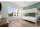 Bright bedroom with a bunk bed, light wood floors, and a large window with neighborhood views at 19 Somerset St, Clearwater Beach, FL 33767