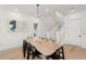 Elegant dining room with a wooden table, modern lighting, and open stairway at 19 Somerset St, Clearwater Beach, FL 33767