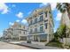 Stunning exterior view of a modern coastal home with multiple balconies and blue accents at 19 Somerset St, Clearwater Beach, FL 33767