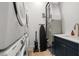 Efficient laundry room setup with stacked washer/dryer, utility sink, and modern appliances at 19 Somerset St, Clearwater Beach, FL 33767