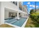Beautiful pool with in-ground hot tub, lounge chairs, and covered outdoor dining area for relaxing and entertaining at 19 Somerset St, Clearwater Beach, FL 33767