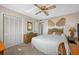 Bedroom features wicker furniture, neutral walls, and a ceiling fan at 19111 Vista Bay Dr # 402, Indian Shores, FL 33785