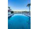 Wide view of the large community pool and condo complex on a bright sunny day at 19111 Vista Bay Dr # 402, Indian Shores, FL 33785