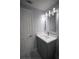 Bathroom featuring modern vanity with quartz countertop and a stylish lighting fixture at 19455 Fort Dade Ave, Brooksville, FL 34601