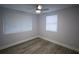 Empty bedroom featuring neutral walls, hardwood floors, and bright natural light at 19455 Fort Dade Ave, Brooksville, FL 34601