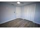 Clean bedroom with hardwood floors, a closet, and ample natural light at 19455 Fort Dade Ave, Brooksville, FL 34601