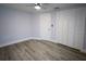 Spacious bedroom with hardwood floors, closet space, and a neutral color palette at 19455 Fort Dade Ave, Brooksville, FL 34601