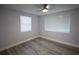 Bright bedroom features hardwood floors, ample natural light, and neutral paint at 19455 Fort Dade Ave, Brooksville, FL 34601