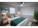 Serene bedroom features a cozy bed, ceiling fan, and bright windows for natural light at 19455 Fort Dade Ave, Brooksville, FL 34601