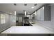 Modern kitchen with stainless steel appliances, gray cabinets, and white marble countertop at 19455 Fort Dade Ave, Brooksville, FL 34601