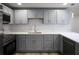 Renovated kitchen with stainless appliances, ample gray cabinet storage, and light countertops at 19455 Fort Dade Ave, Brooksville, FL 34601