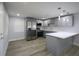 Kitchen featuring stainless steel appliances, gray cabinetry and luxury vinyl plank flooring at 19455 Fort Dade Ave, Brooksville, FL 34601