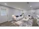 Bright, staged living room with modern furniture, neutral tones, and lots of natural light at 19455 Fort Dade Ave, Brooksville, FL 34601