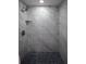 Beautifully tiled shower with a rainfall shower head and pebble tile shower pan at 19455 Fort Dade Ave, Brooksville, FL 34601