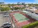 Aerial view of the community featuring the tennis court, parking, pool, clubhouse, landscaping, and surrounding buildings at 1986 Pelican Landing Blvd # 1514, Clearwater, FL 33762
