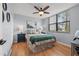 Bedroom with neutral decor, wood floors, ceiling fan and a picture window with blinds at 1986 Pelican Landing Blvd # 1514, Clearwater, FL 33762