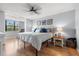 Bright bedroom with a ceiling fan, comfortable bed, and a large window for natural light at 1986 Pelican Landing Blvd # 1514, Clearwater, FL 33762