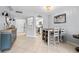 Open-concept dining room featuring tile flooring, light blue walls, and access to the kitchen and living room at 1986 Pelican Landing Blvd # 1514, Clearwater, FL 33762